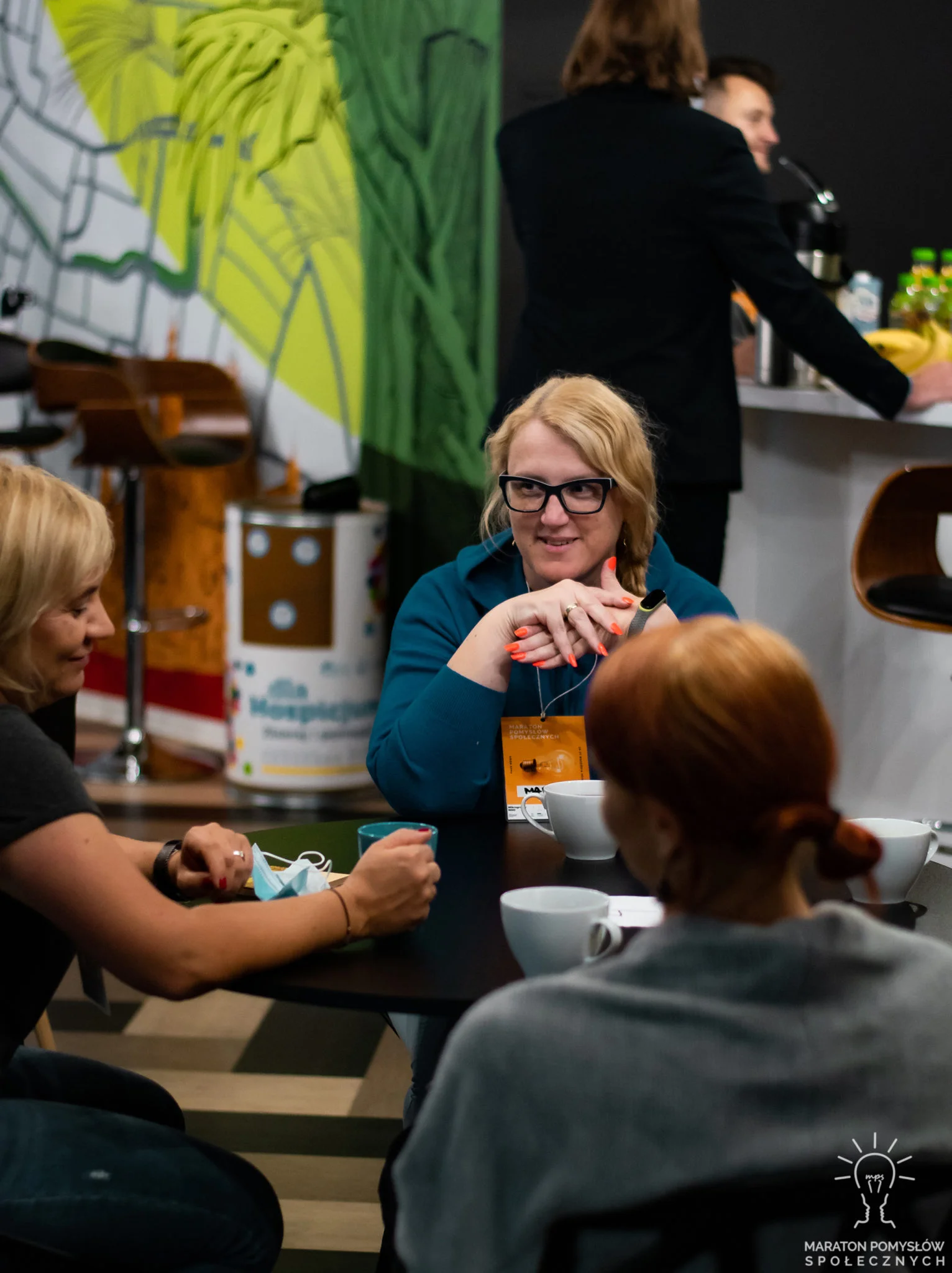 Grupa ludzi w pomieszczeniach Biznes Zone czekająca na rozpoczęcie konkursu Maraton Pomysłów Społecznych: Fake News